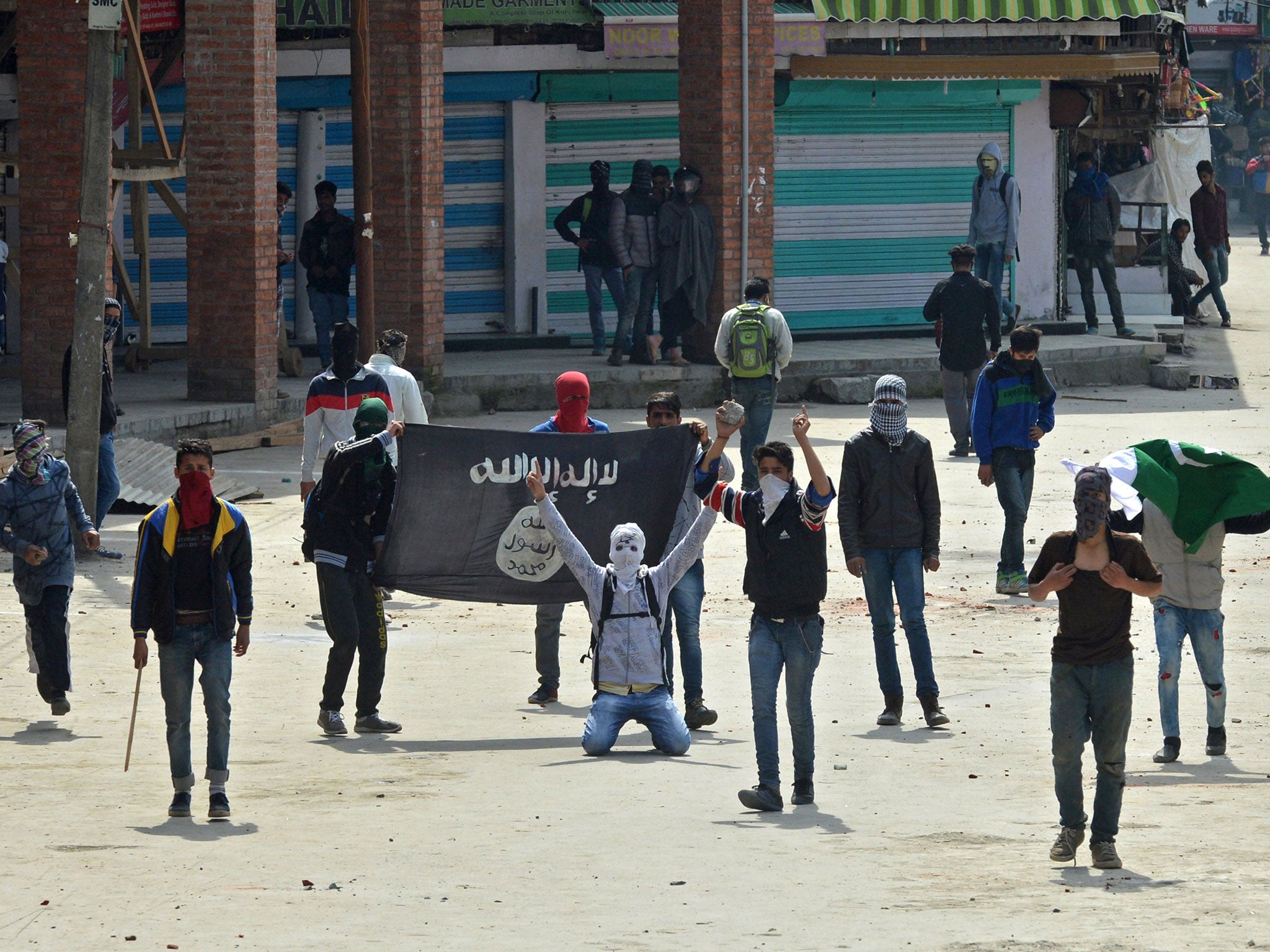 Kashmiri Muslim protesters hold Isis and Pakistani flags as they shout anti-India slogans during clashes in downtown Srinagar on 8 April, 2016