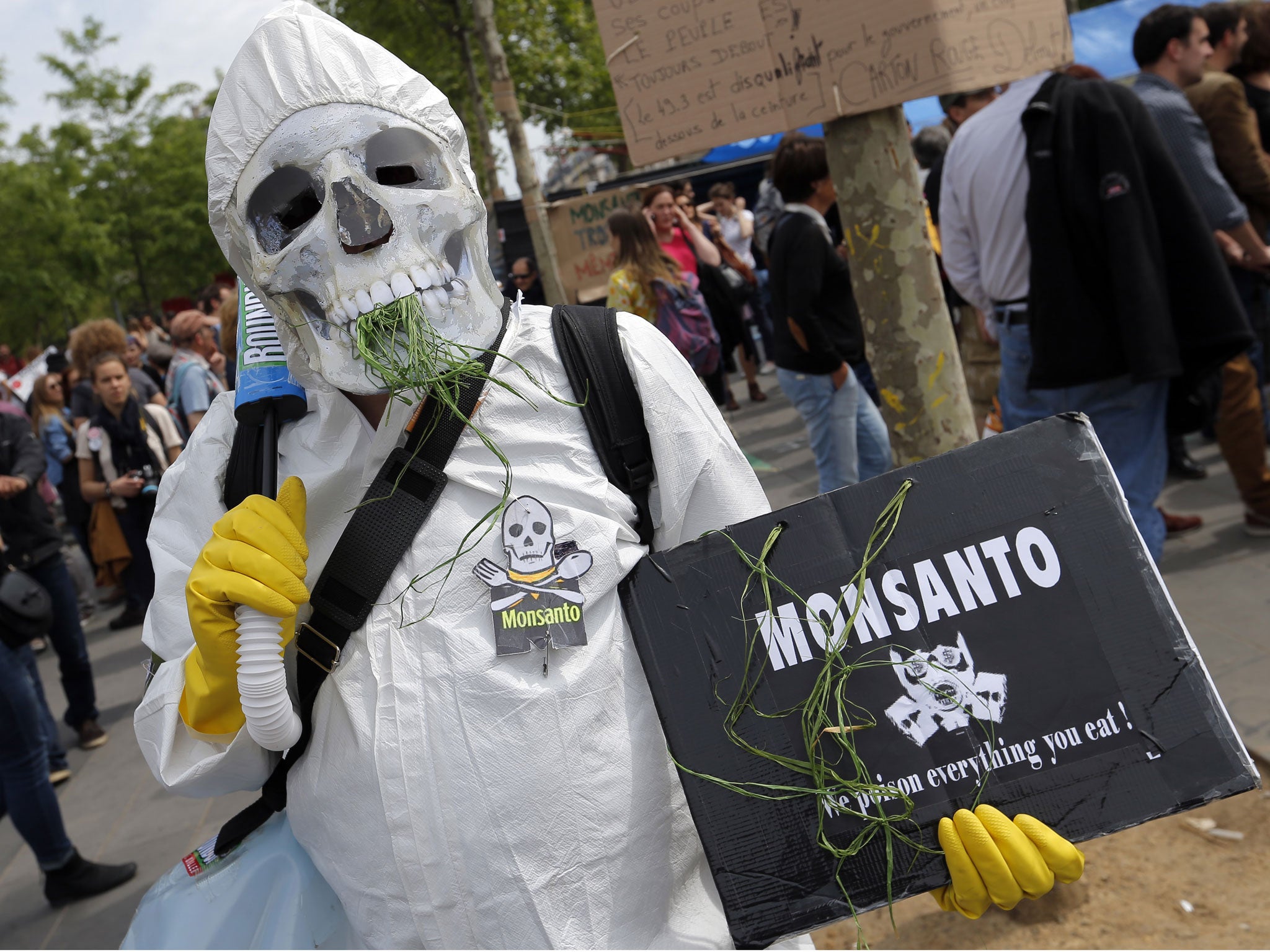 A protester wearing a chemical protection takes part in a March Against Monsanto at Place de la Republique in Paris, Saturday, May 21, 2016