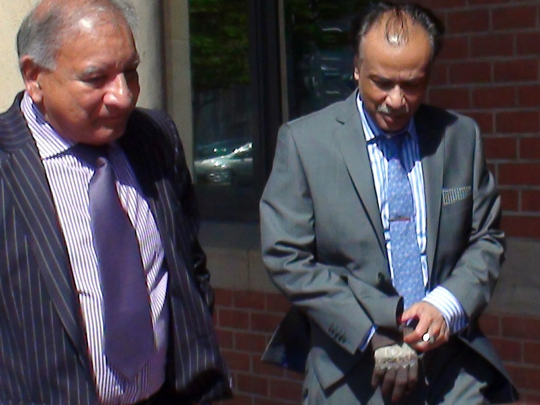 Restaurant owner Mohammed Zaman (right) leaves Teesside Crown Court, he is accused of the manslaughter of a customer who suffered a fatal allergic reaction to peanuts after eating a takeaway curry