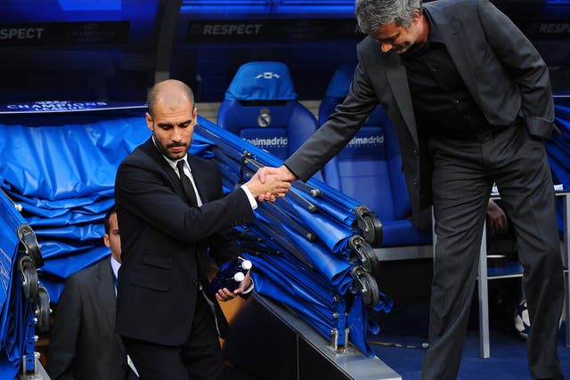 Barcelona's Pep Guardiola and Real's Jose Mourinho shake hands during their at times bitter rivalry in Spain