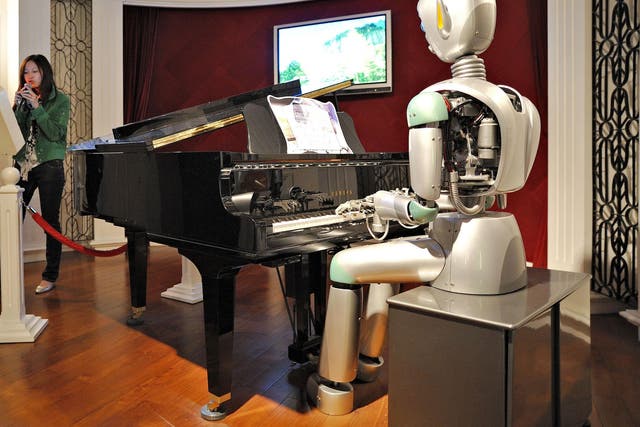 A woman sings karaoke to a robotic piano accompaniment at the Science and Technology Museum in Shanghai