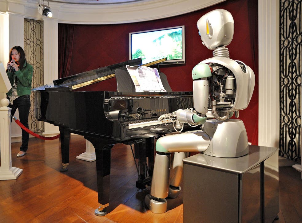 A woman sings karaoke to a robotic piano accompaniment at the Science and Technology Museum in Shanghai