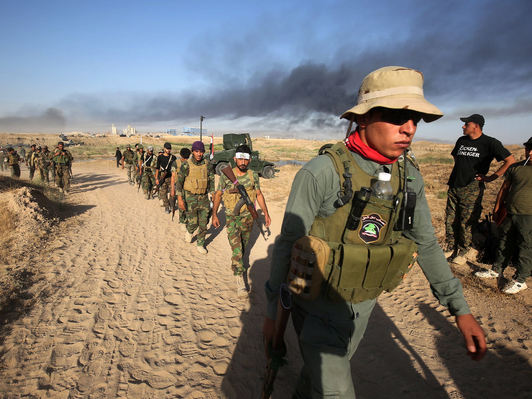 Soldiers advance toward Fallujah, the scene of deadly battles during the US occupation of Iraq