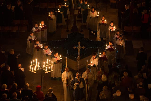 Choristers carry candles during the annual 'darkness to light' advent procession at Salisbury Cathedral