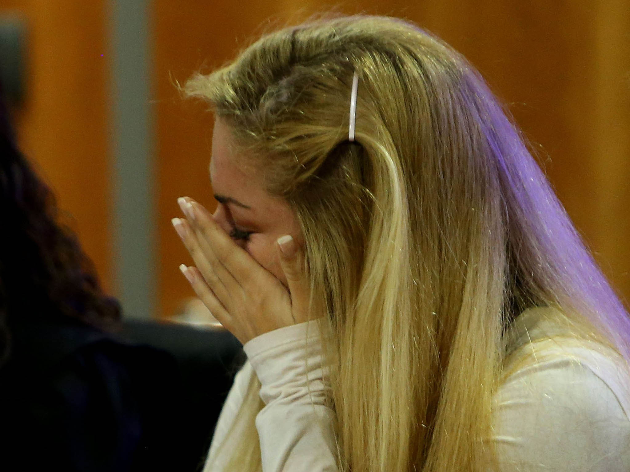 Mayka Marica Kukucova wipes her face as she appears in court in Malaga, Spain