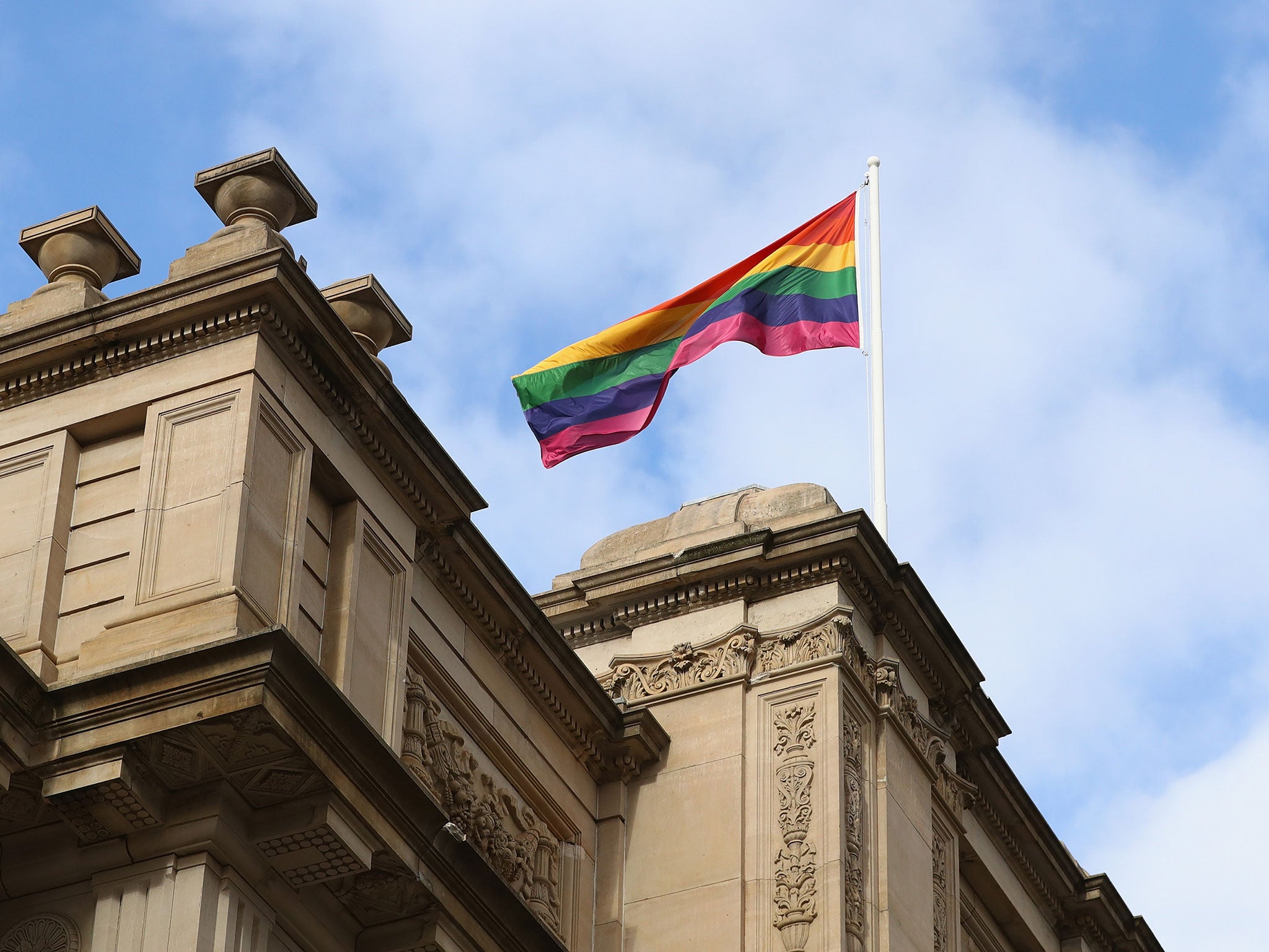 A rainbow flag is seen above Parliament House as Premier Daniel Andrews makes an apology to the Victorian Gay community