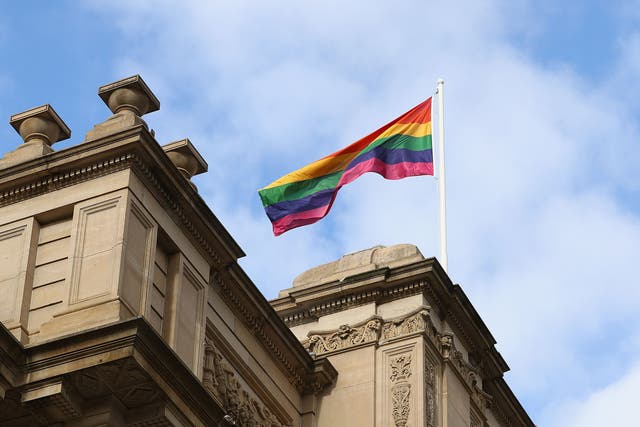 A rainbow flag is seen above Parliament House as Premier Daniel Andrews makes an apology to the Victorian Gay community