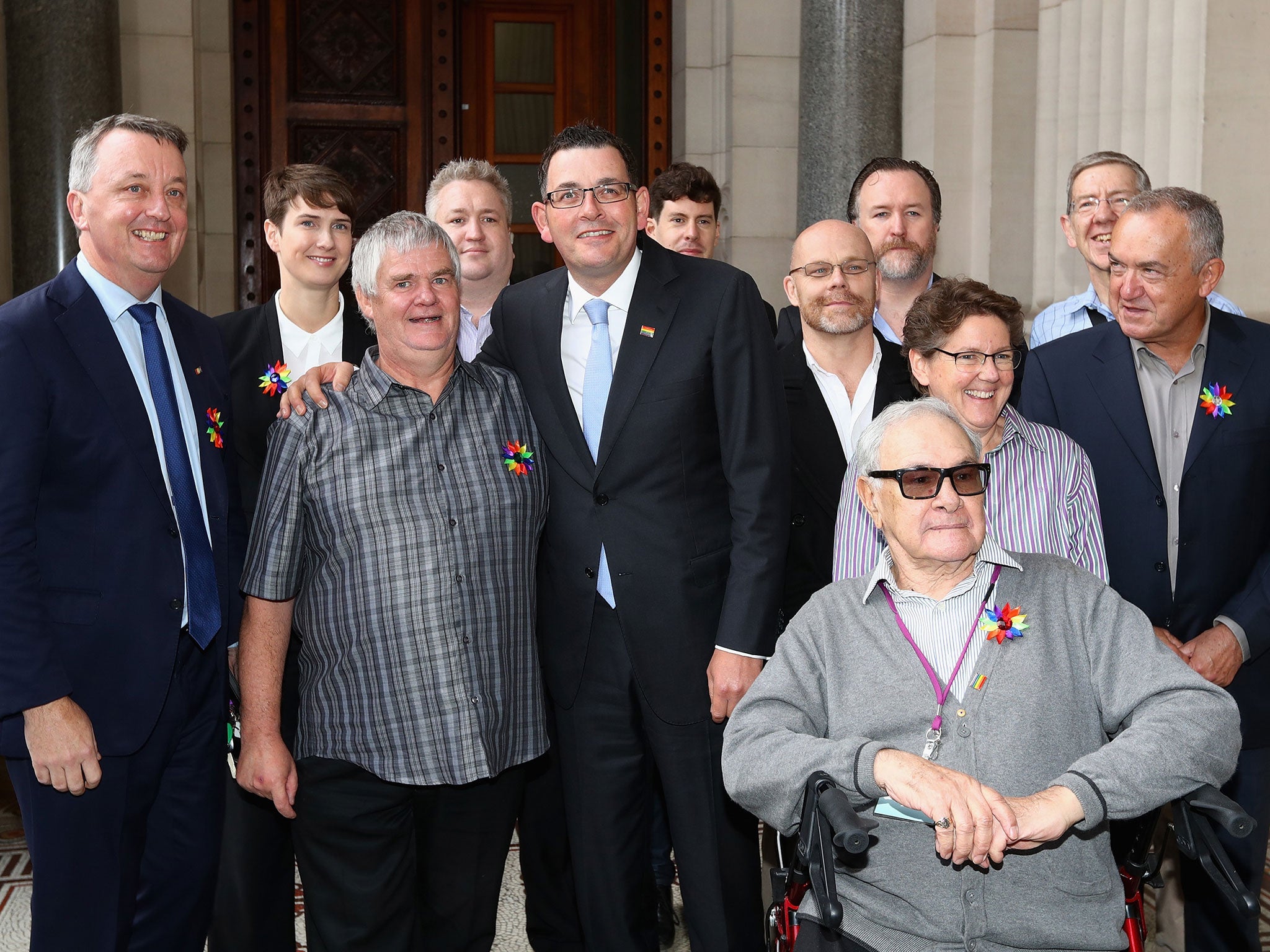 Premier Daniel Andrews poses with former victims and representitives, before making an apology to the Victorian Gay community at Parliament House