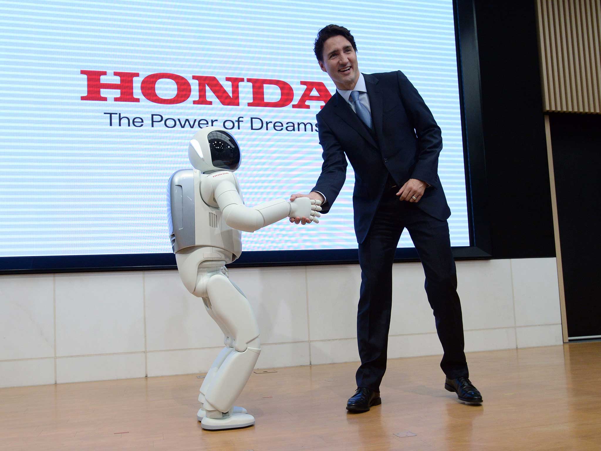 Canadian Prime Minister Justin Trudeau meets Honda Robot Asimo as he visits Honda Motor Co. headquarters in Tokyo, Japan