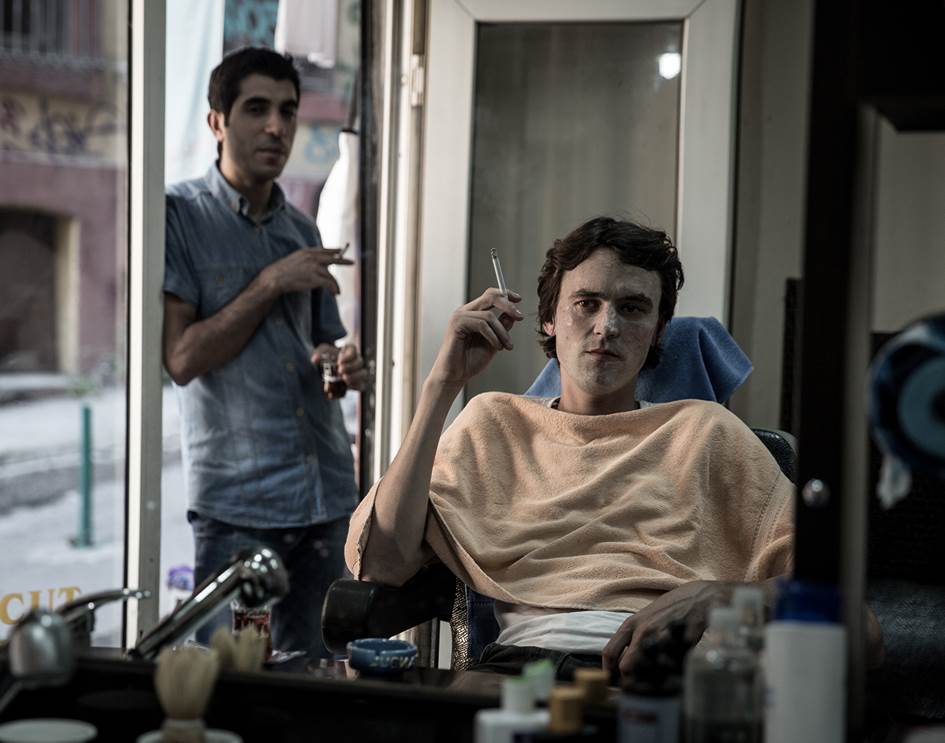 Artist Fuller smoking a cigarette inside a Barber's in Istanbul, 2013