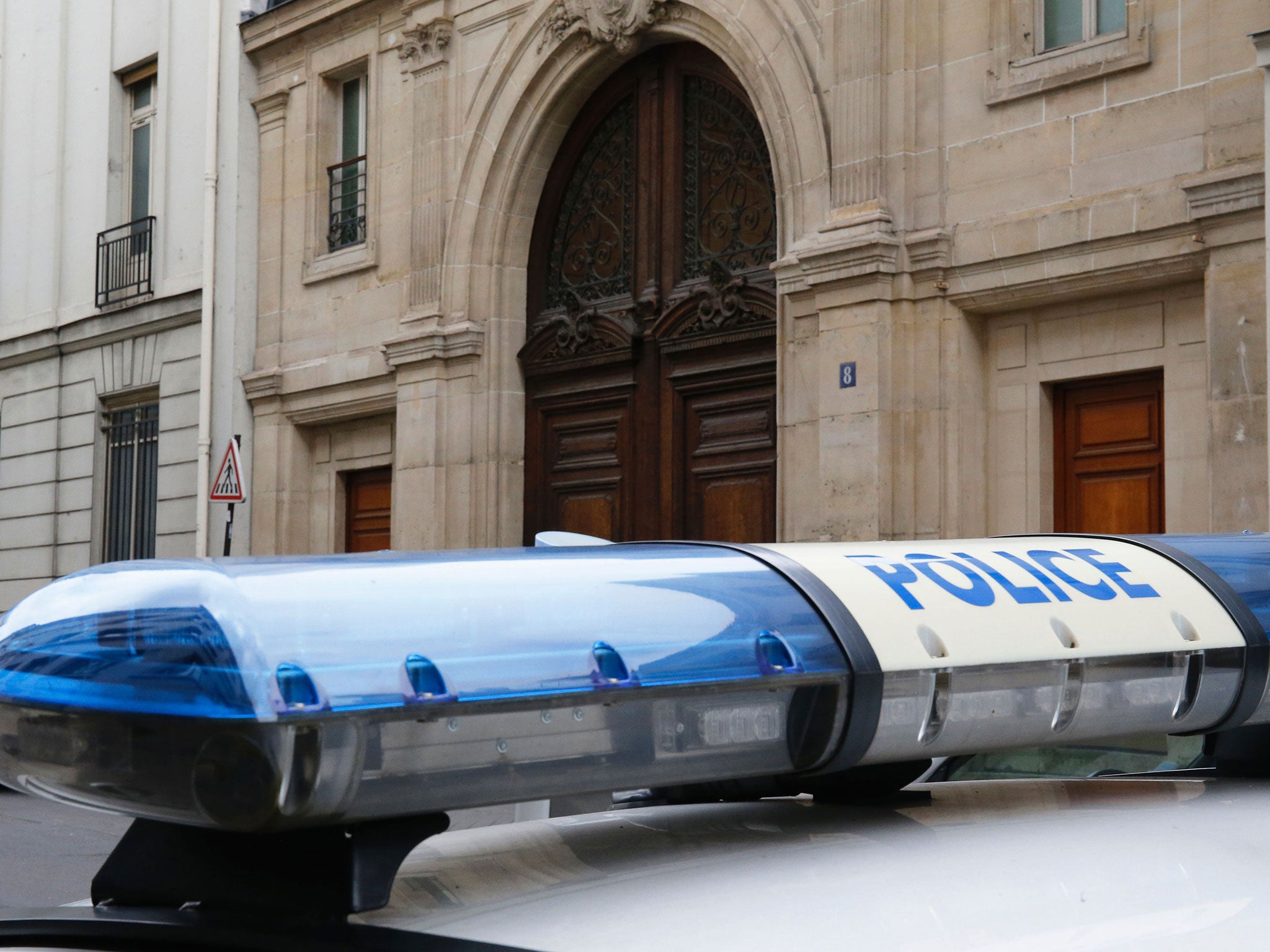 A police car outside Google's Paris offices during a raid by investigators