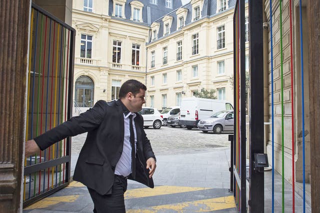 A guard closes the gate of Google's Paris headquarters after a raid