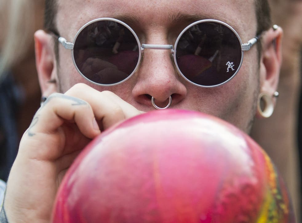 A protester inhales nitrous oxide. Research suggests the ban will not affect regular use of legal highs