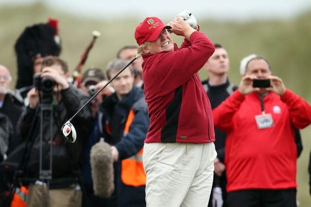 Donald Trump hits the first ball at the opening of his controversial £100m course in Scotland