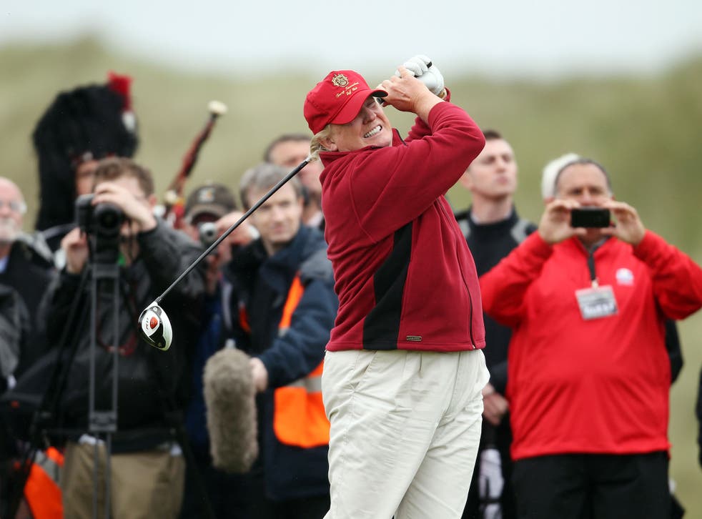 Donald Trump hits the first ball at the opening of his controversial £100m course in Scotland