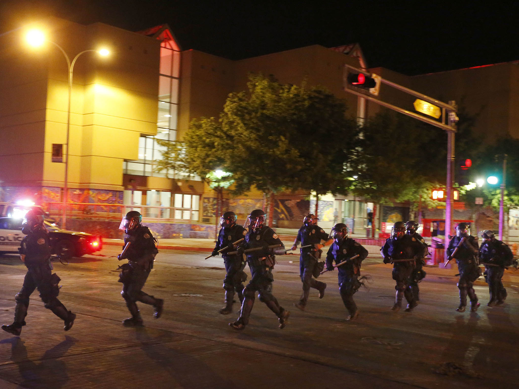 Riot police respond to anti-Trump protests following a rally and speech by Republican presidential candidate Donald Trump