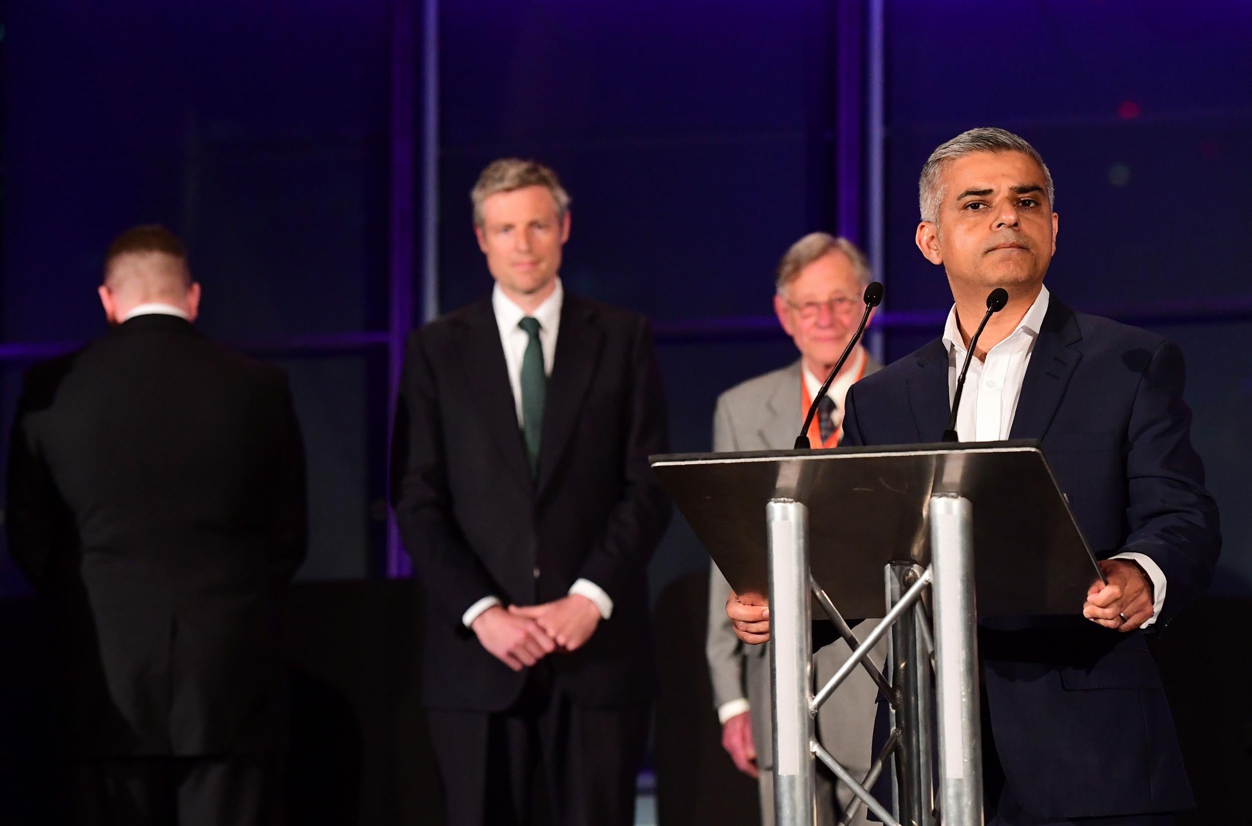 Paul Golding turns his back while Sadiq Khan gives hs victory speech at City Hall