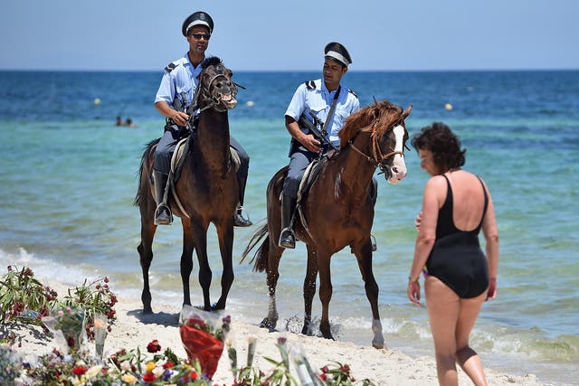 Armed police patrol Marhaba beach in Sousse following last June's attack