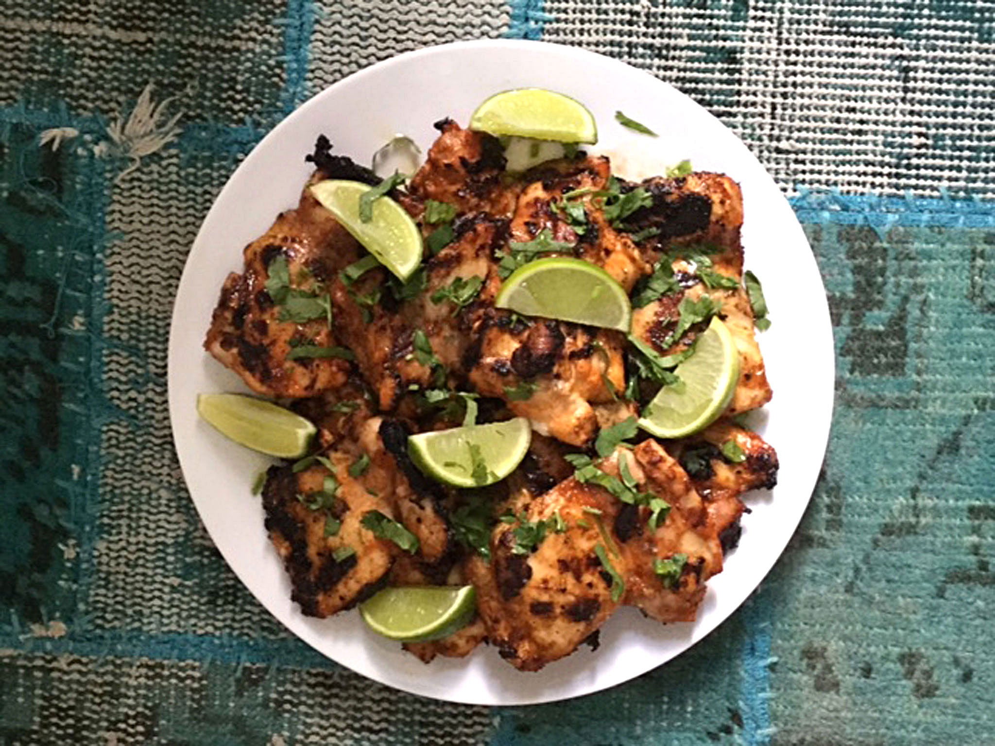 Serve the chicken on a platter with lime wedges and chopped coriander