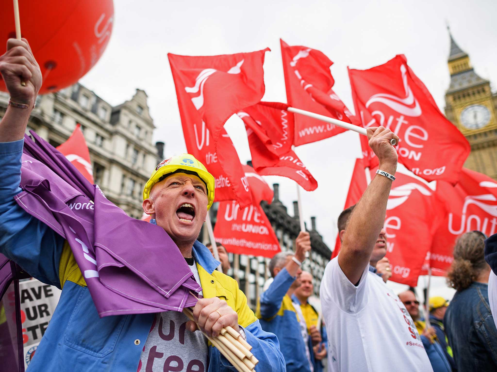 Steel workers wave banners as they take part in protest march through central London