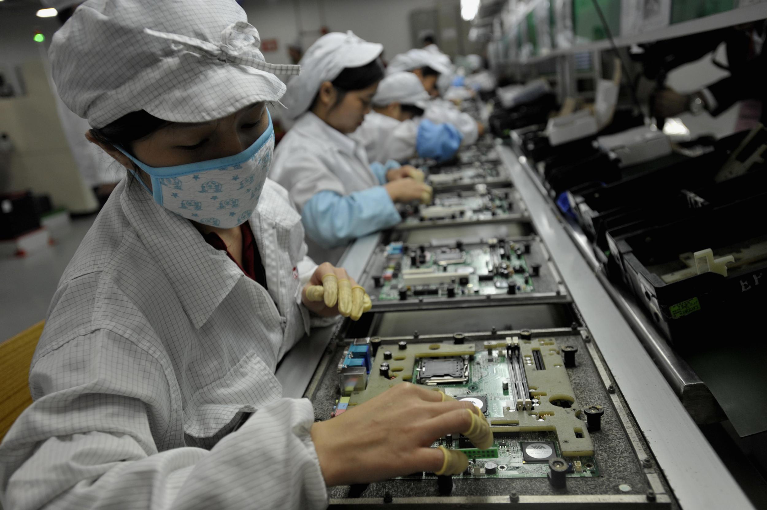 Workers assemble components at the Foxconn factory in Shenzen, China