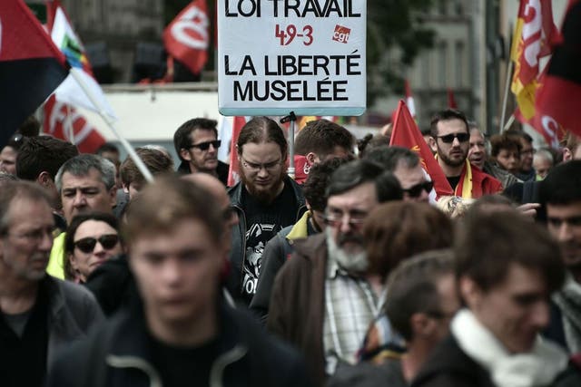 Demonstrators take part in a protest and hold a placard reading "Labour reform, muzzled freedom" against the government's planned labour law reforms in Strasbourg, eastern France