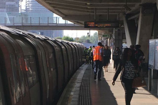 Canning Town station was evacuated after a woman's leg became trapped between a Tube train and the platform on 26 May