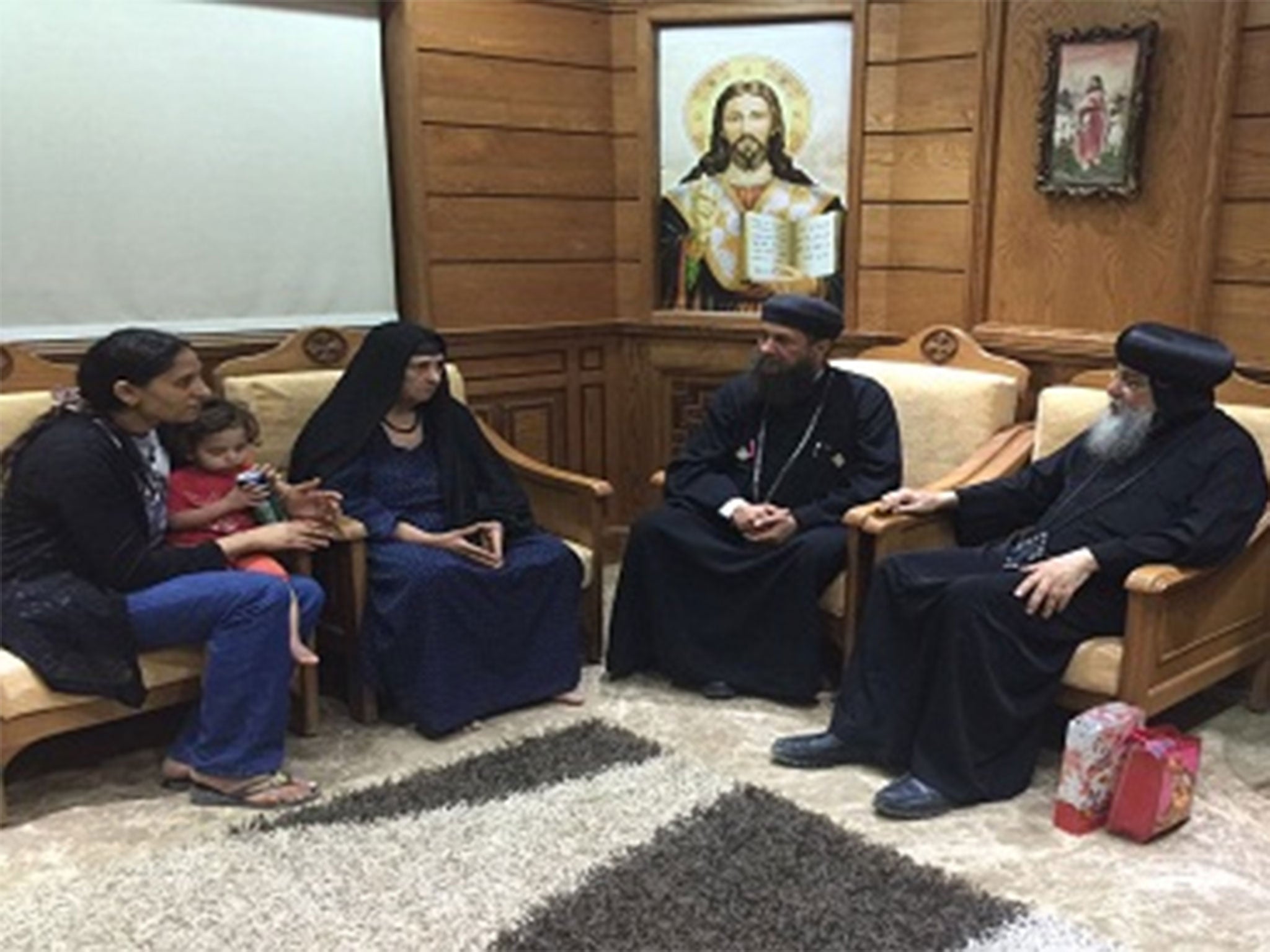 &#13;
The elderly woman meets with church leaders to discuss the mob's actions, in this image released by the Diocese of Minay and Abu Qirqas&#13;