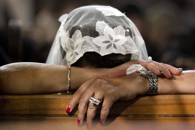 In this file photo, a Coptic Christian grieves during prayers for the departed after the EgyptAir crash, at Al-Boutrossiya Church, the main Coptic Cathedral complex, in Cairo, Egypt
