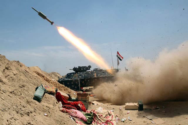 Iraqi government forces fire a rocket north-east of Fallujah