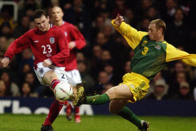 Rooney is closed down by Australia defender Craig Moore as he makes his England debut at Upton Park 13 years ago (Getty)