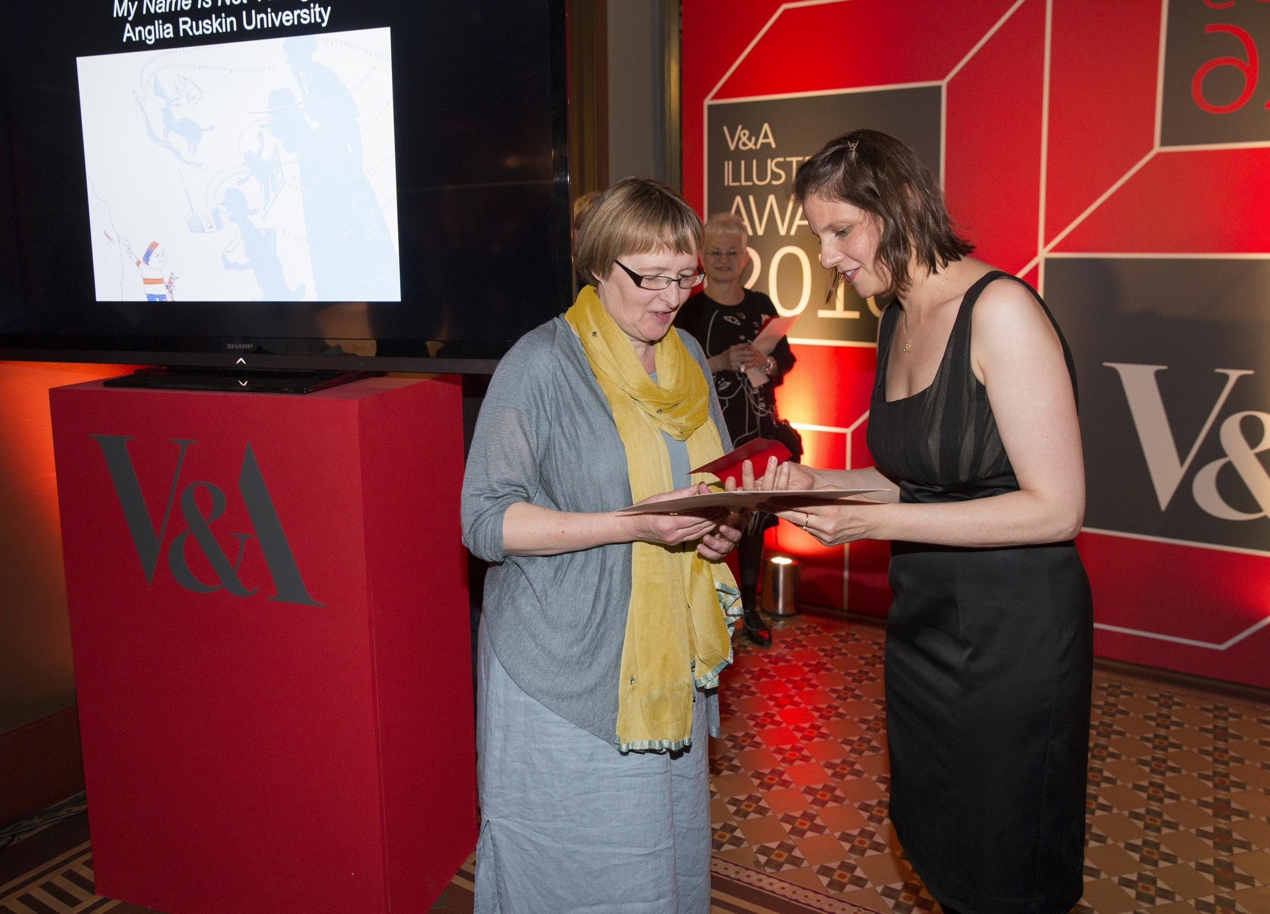 Kate Milner, pictured left, collects her award for Student Illustrator of the Year at V&amp;A’s Illustration Awards