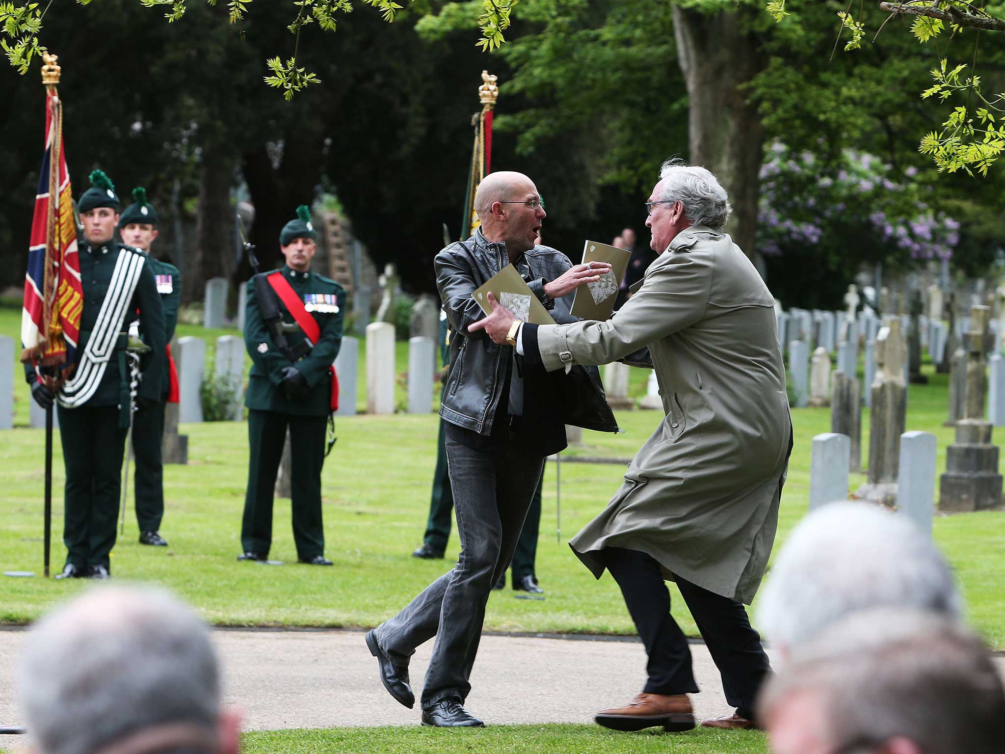 Canadian Ambassador to Ireland Kevin Vickers wrestles with a protester (right) during a State ceremony to remember the British soldiers who died during the Easter Rising at Grangegorman Military Cemetery, Dublin.