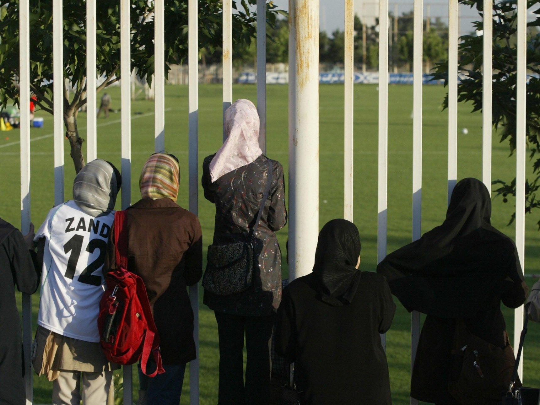 Iranian women watch a training session of Iran's national football team from behind a fence as females were not allowed to enter the stadium at Tehran's Azadi (Freedom) sport complex.