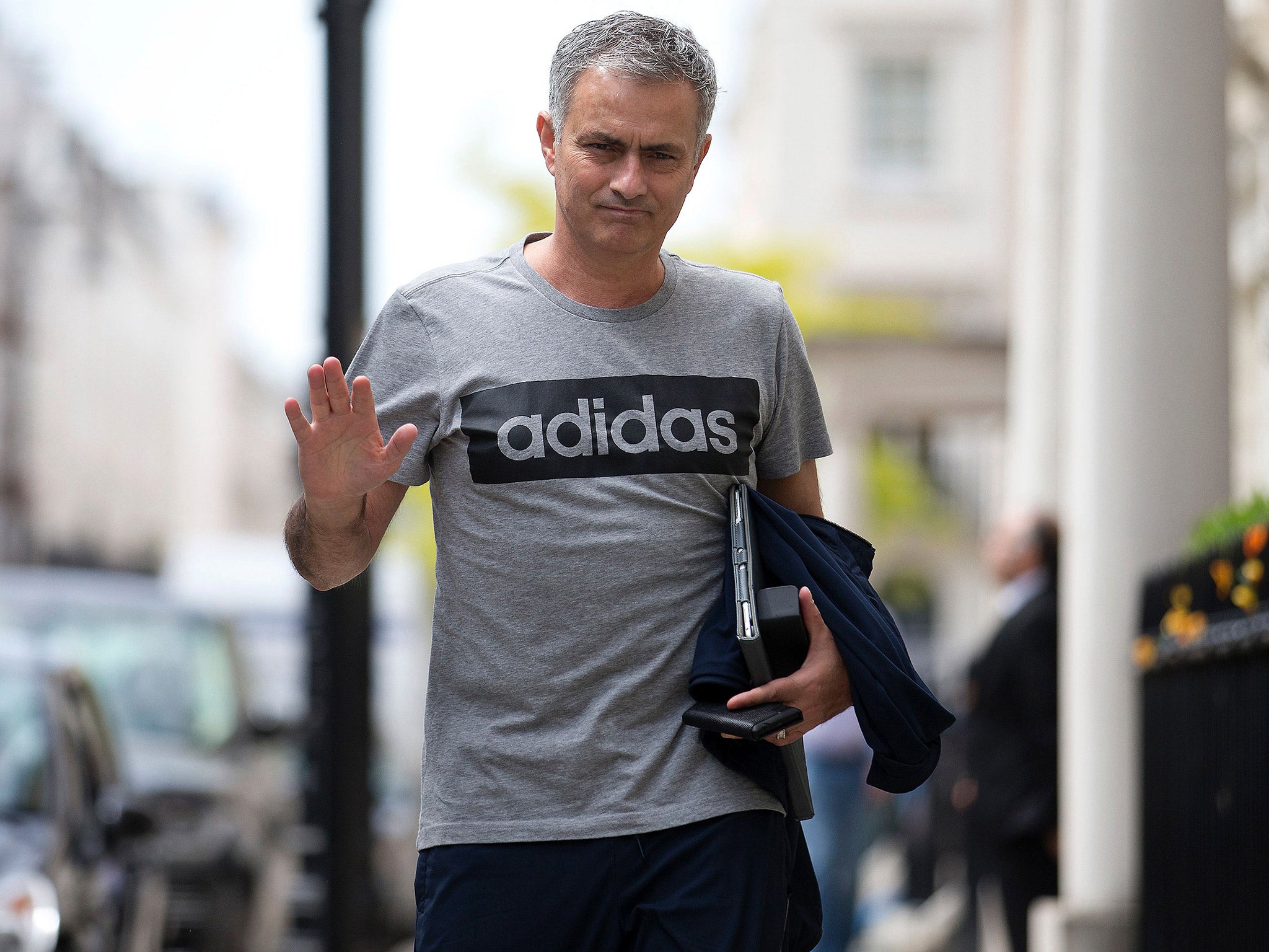 Jose Mourinho walks along a London street towards his home after being named Manchester United manager