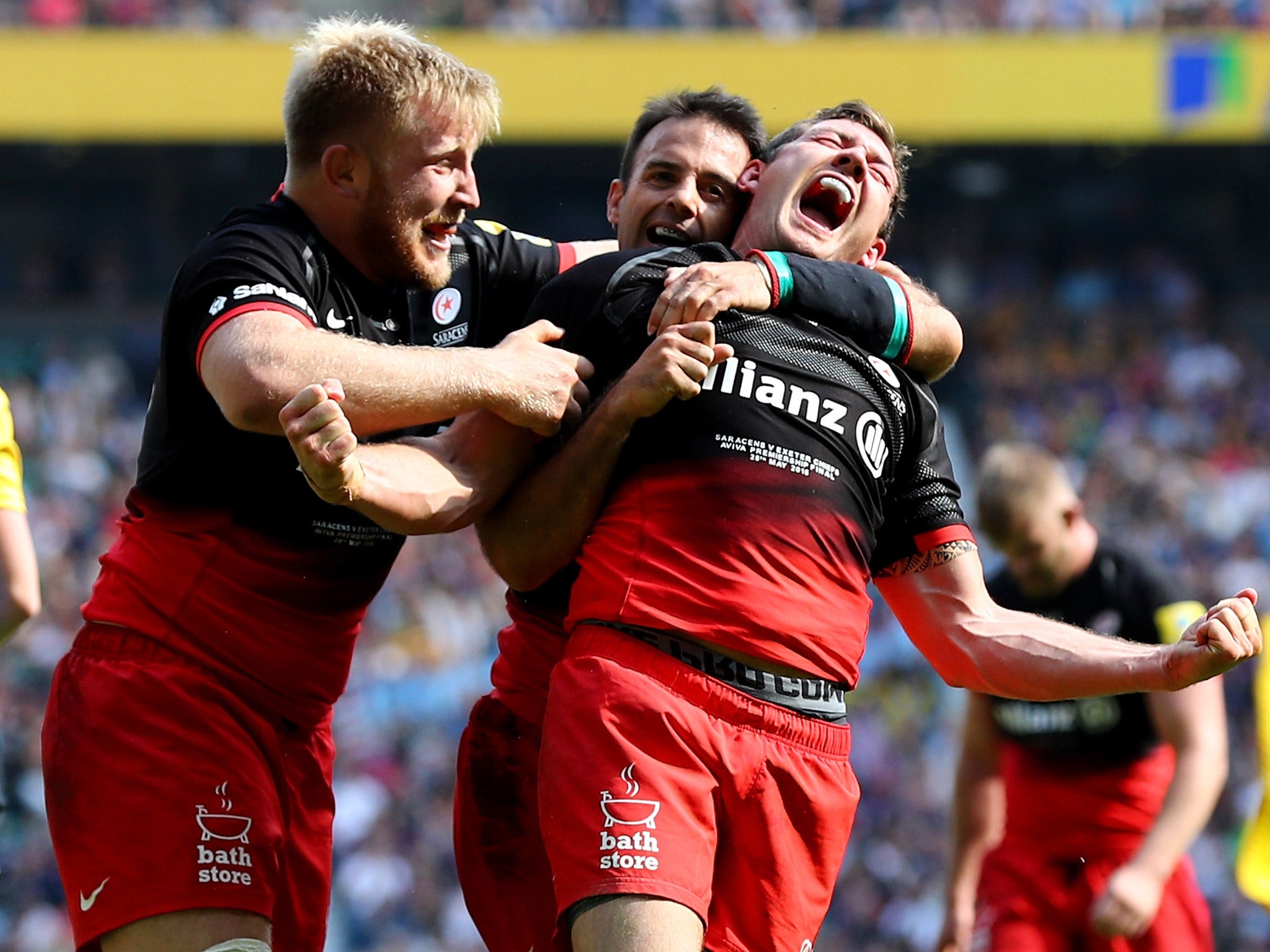 Alex Goode celebrates with his Saracens team-mates after scoring the third try