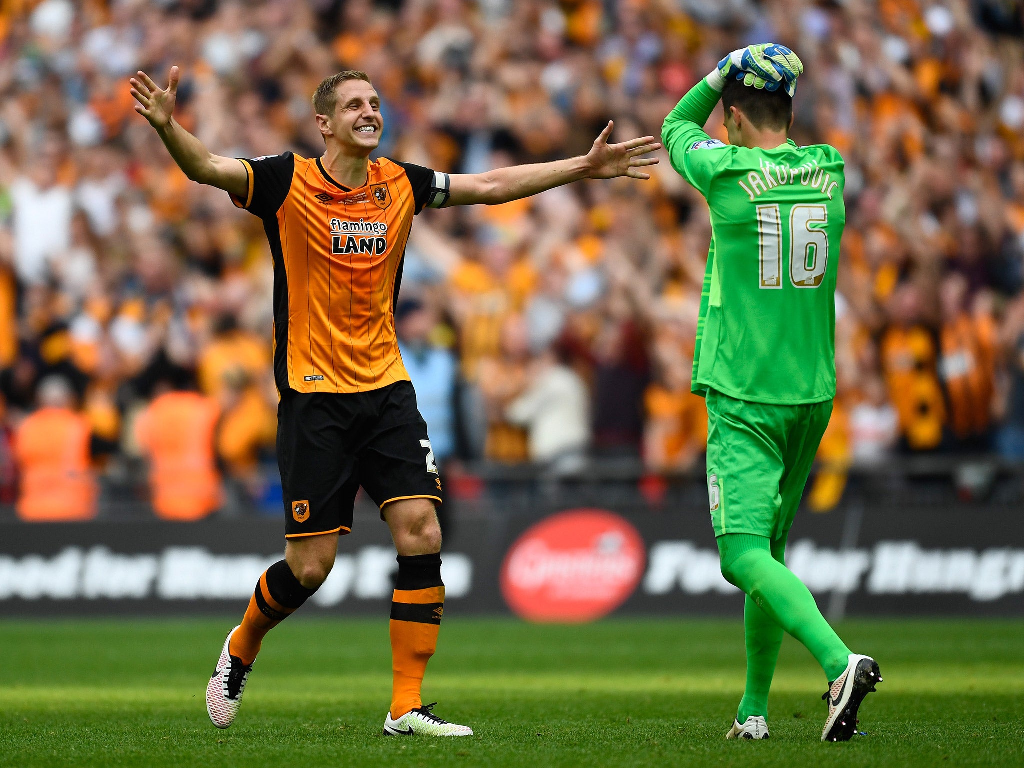 Michael Dawson celebrates with Hull team-mate Eldin Jakupovic after securing promotion