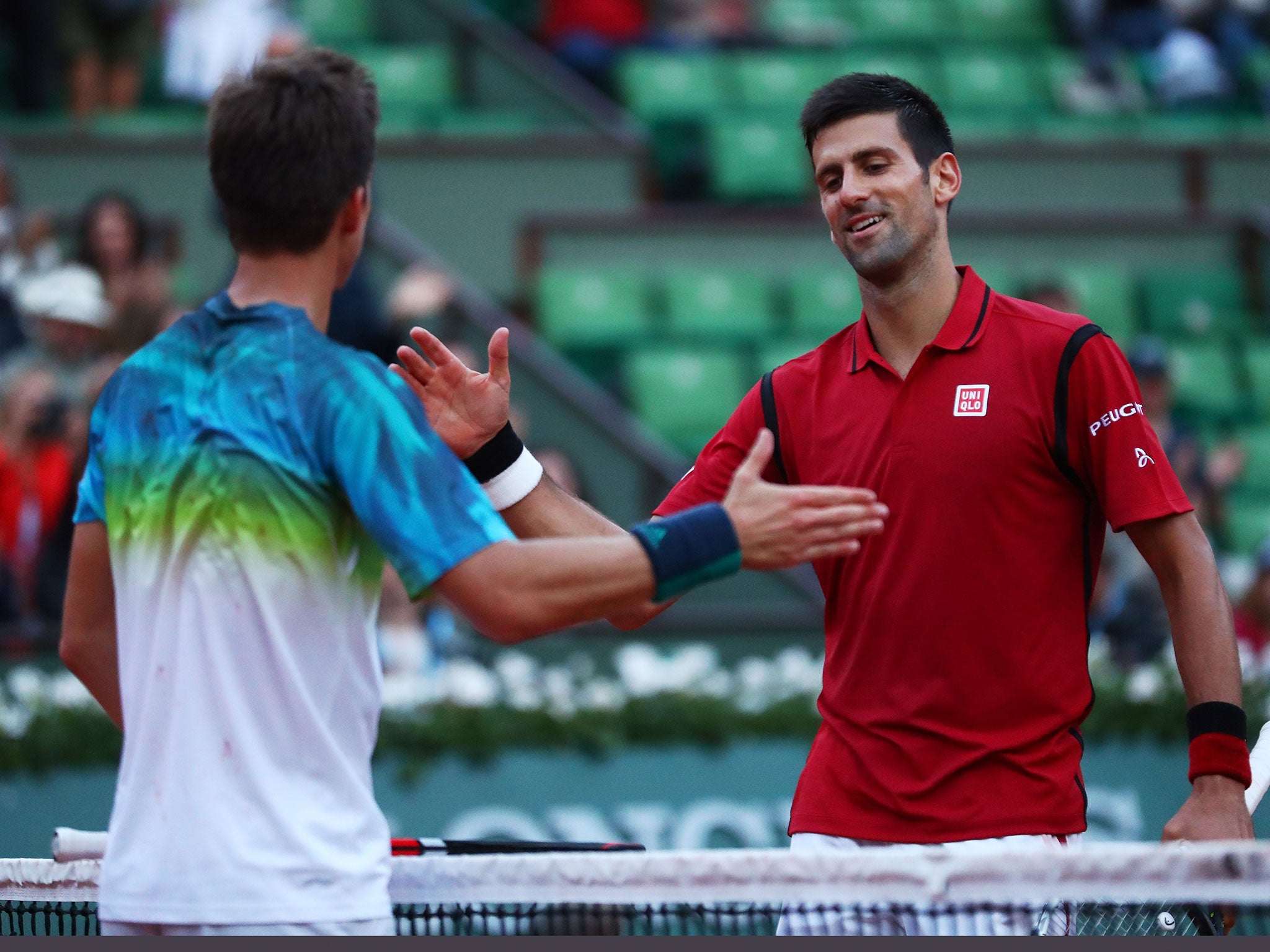 Novak Djokovic shakes hands with Aljaz Bedene following the world No 1's third round victory
