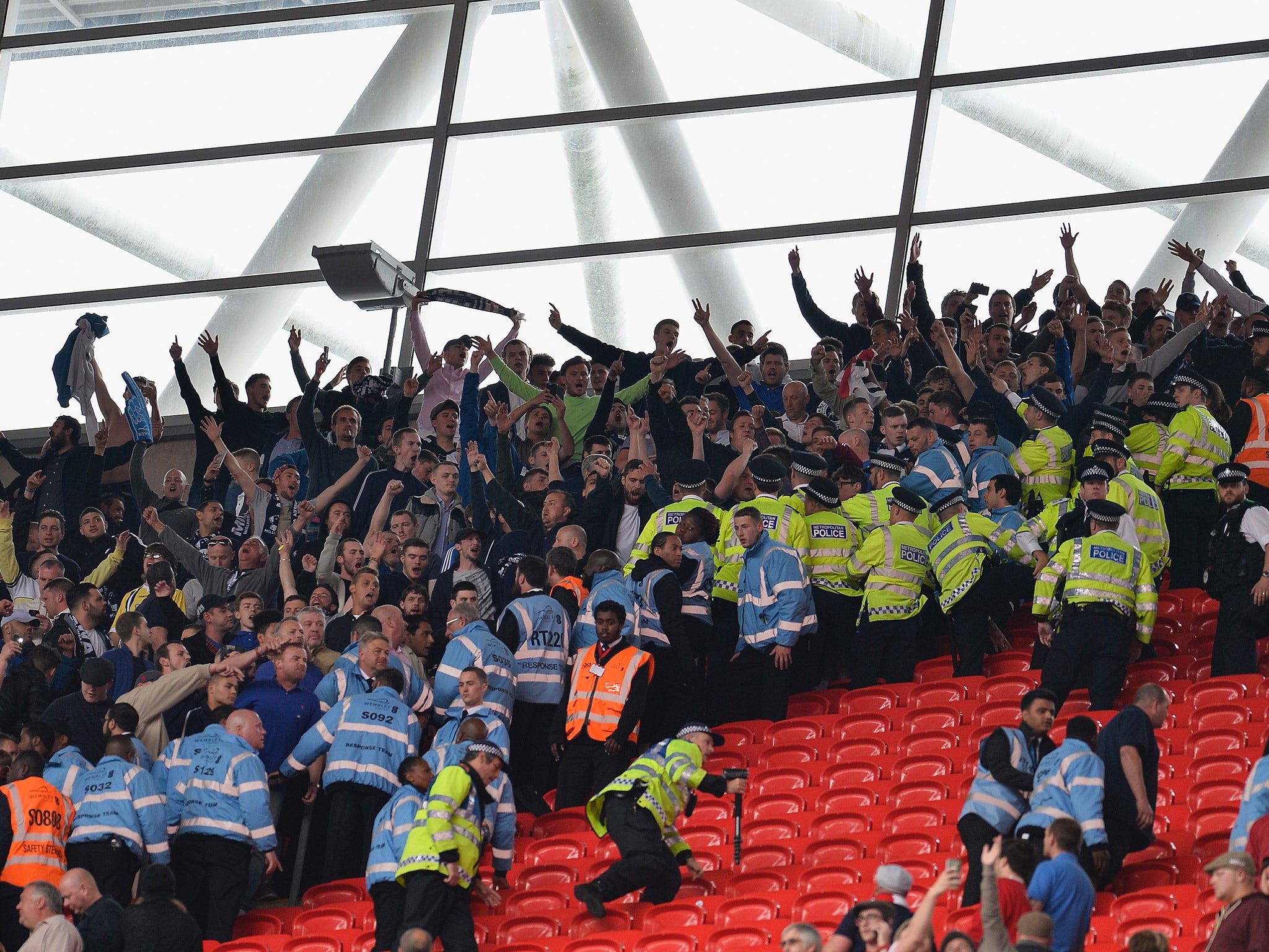 Millwall fans clash with police after attempting to charge the Barnsley fans