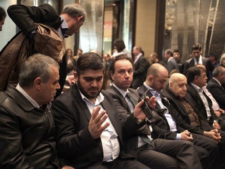 (L-R) Assad Zoubi, Mohammad Alloush, leaders of Syrian opposition delegation, talk prior to Riad Hijab's, head of the Syrian opposition's High Negotiations Committee and former Prime Minister of Syria