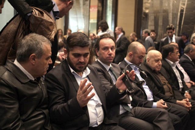 (L-R) Assad Zoubi, Mohammad Alloush, leaders of Syrian opposition delegation, talk prior to Riad Hijab's, head of the Syrian opposition's High Negotiations Committee and former Prime Minister of Syria
