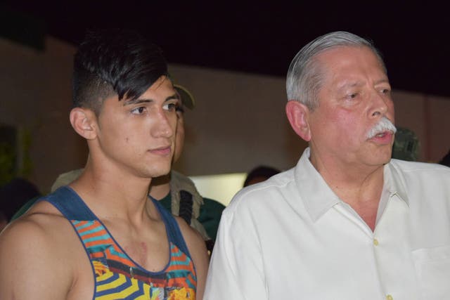Mexican soccer player Alan Pulido, left, stands next to Tamaulipas State Gov. Egidio Torre Cantu after Pulido was rescued from kidnappers early Monday, May 30, 2016 in Ciudad Victoria, the capital of Tamaulipas State, Mexico
