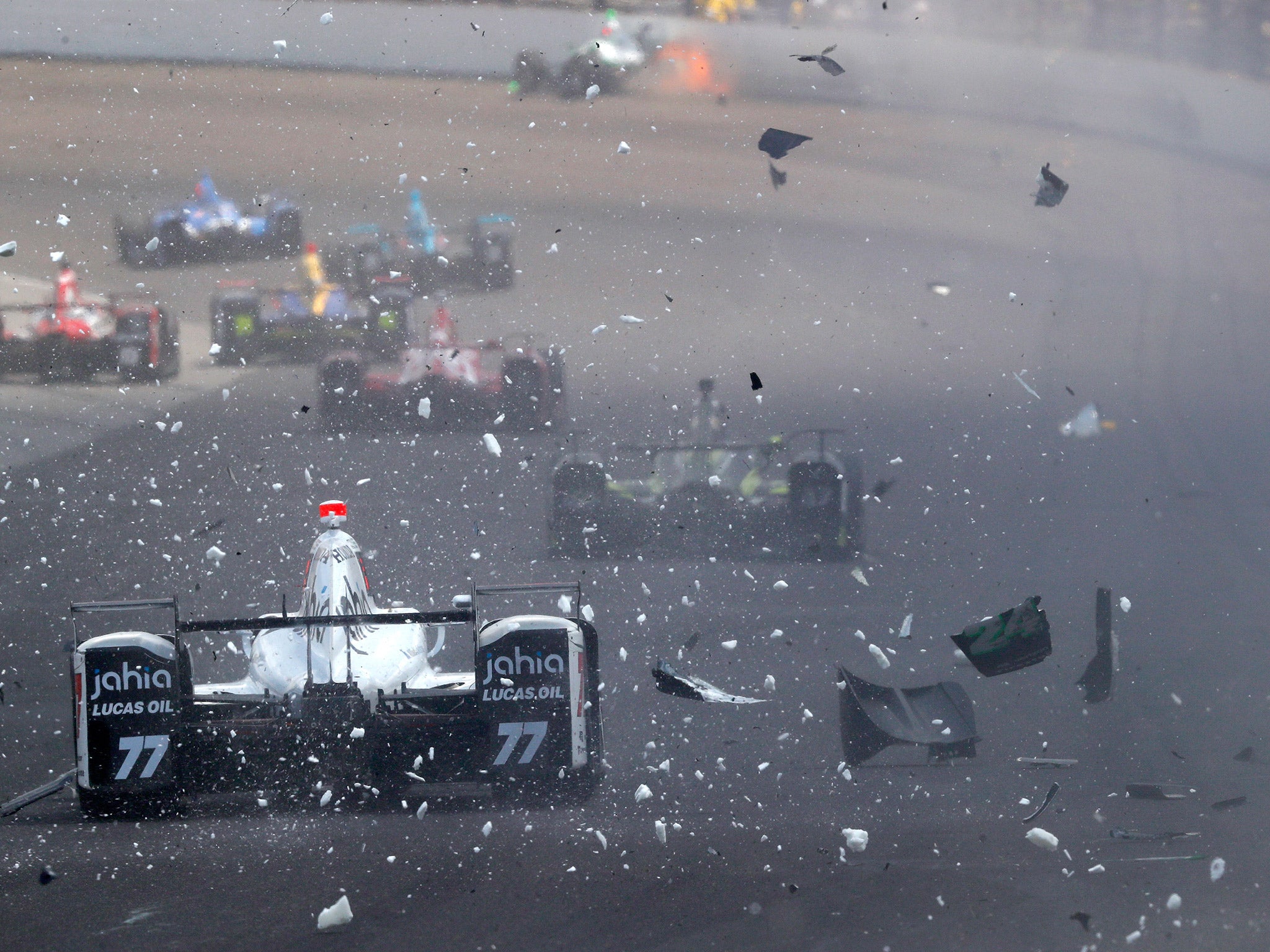 Oriol Servia drives through debris caused by Sage Karam's heavy accident