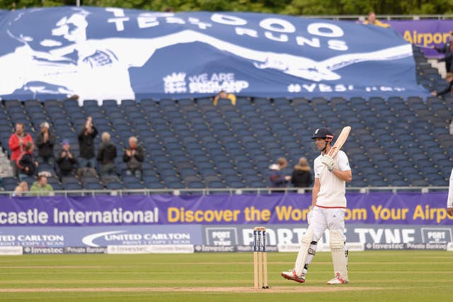 Alastaor Cook celebrates after reaching 10,000 Test runs