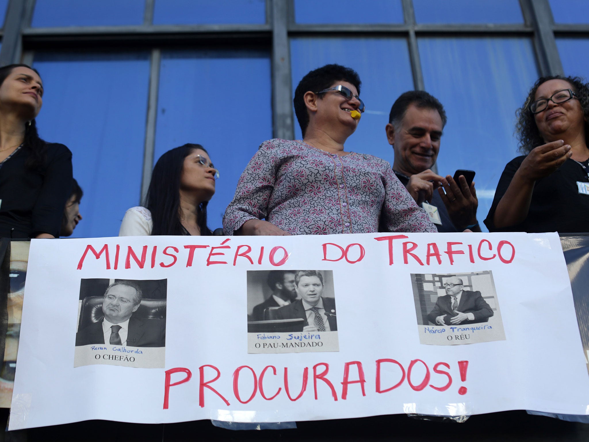 Ministerial workers take part in a protest demanding the resignation of Fabiano Silveira