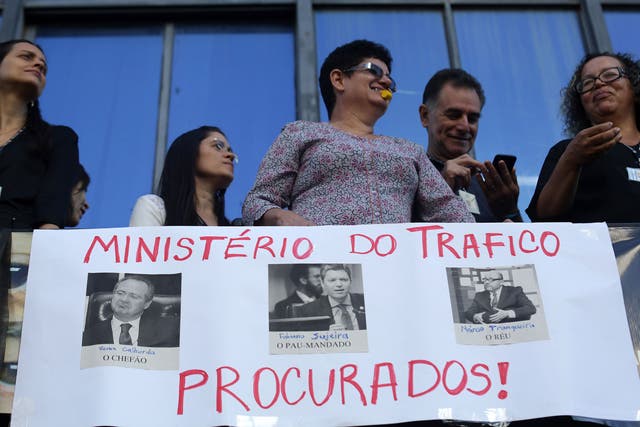 Ministerial workers take part in a protest demanding the resignation of Fabiano Silveira