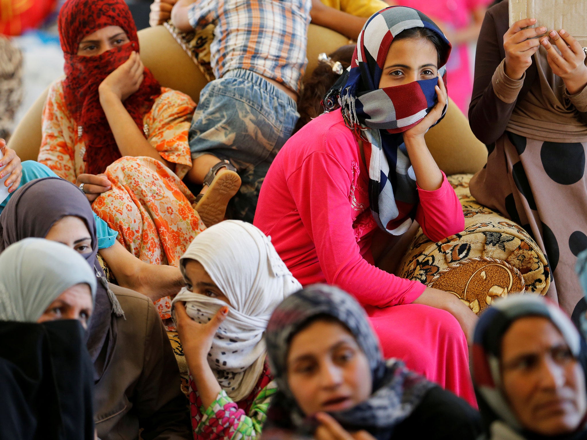 Civilians who fled their homes due to clashes on the outskirts of Fallujah, gather in the town of Garma, Iraq, on 30 May