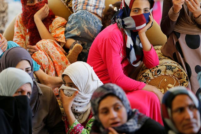 Civilians who fled their homes due to clashes on the outskirts of Fallujah, gather in the town of Garma, Iraq, on 30 May