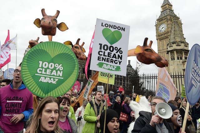 Protesters outside Parliament call for the end of the use of fossil fuels