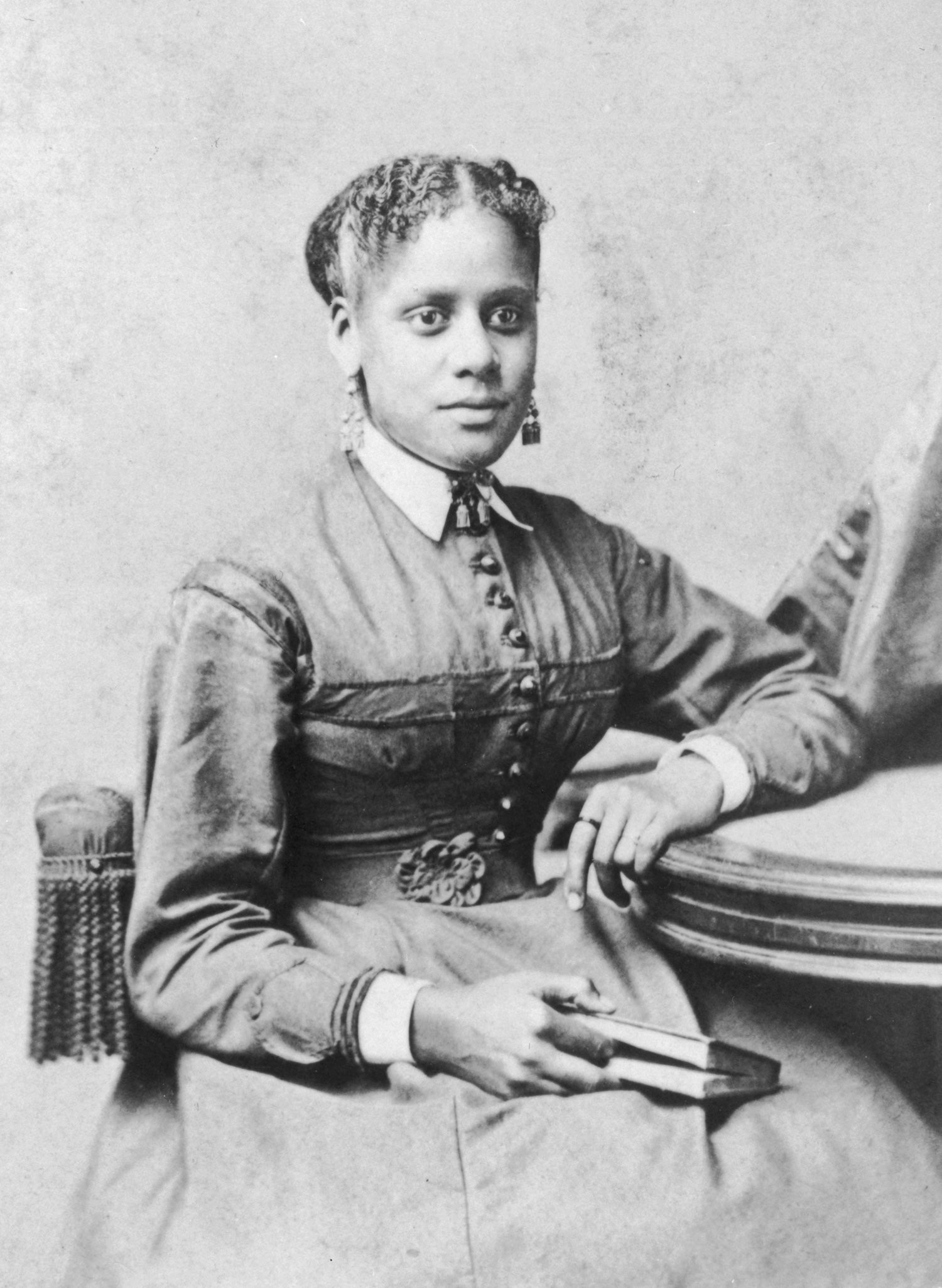 Lost in time: Portrait of an unidentified African-American woman seated at a table, holding a book in her lap, Hartford, Connecticut, circa 1865.